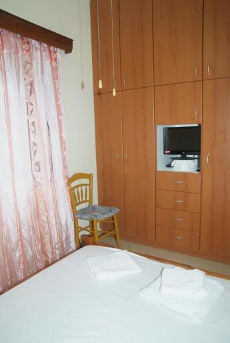 Кровать или кровати в номере Tourloti Village House