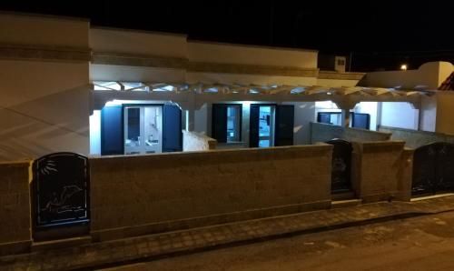a building with blue doors on a street at night at Casa Roberto in Campomarino