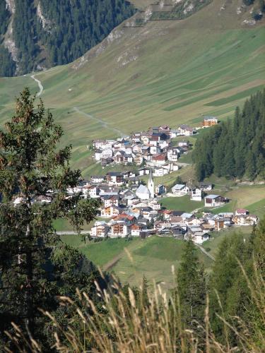 a small town in a green valley with mountains at Apartment MEZPRA in Samnaun