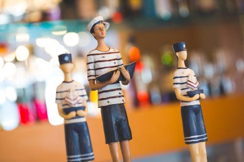 three toy figurines of men standing next to each other at Lu' Hotel Riviera - Carloforte in Carloforte