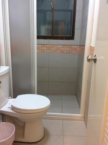 a bathroom with a toilet and a shower at 3 Feet Cat in Nangan