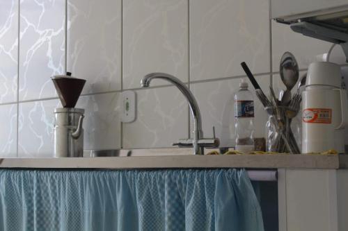 a kitchen counter top with a sink and a sink at Stay in Itatiaia in Itatiaia
