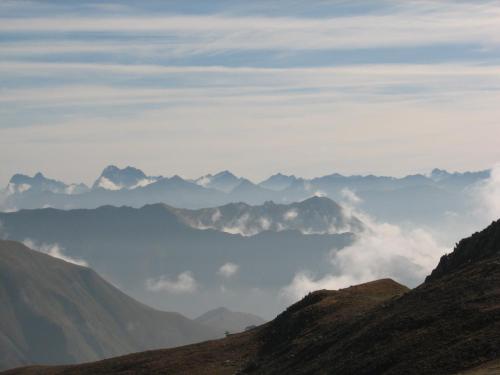 a view of a mountain range in the clouds at Apartment MEZPRA in Samnaun