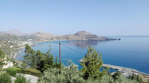 a view of a body of water with trees at Elgini Studios in Plakias