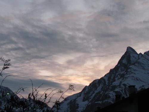 a snow covered mountain with a cloudy sky at Apartment MEZPRA in Samnaun
