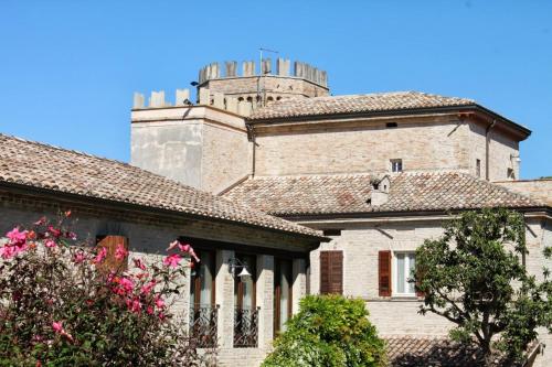 a building with a tower on top of it at Castello Montegiove in Fano