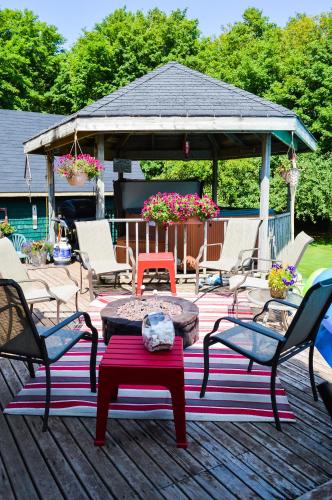 a patio with a gazebo with chairs and a table at Bugaboo Cottages in Summerside