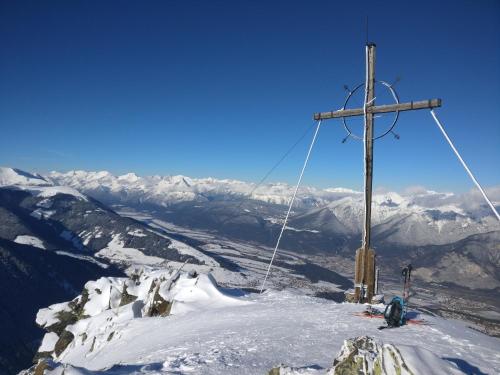 a cross on the top of a snow covered mountain at Haus Falkner in Mutters