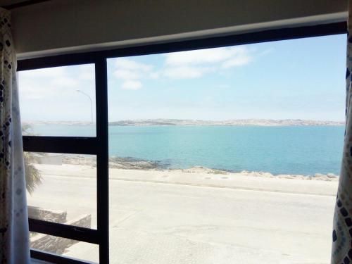 a view of the ocean from a window at Kairos Cottage B&B in Lüderitz