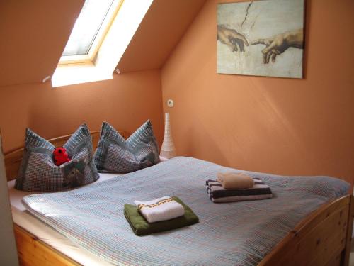 a bedroom with a bed with pillows and a window at Villa Regina in Schierke