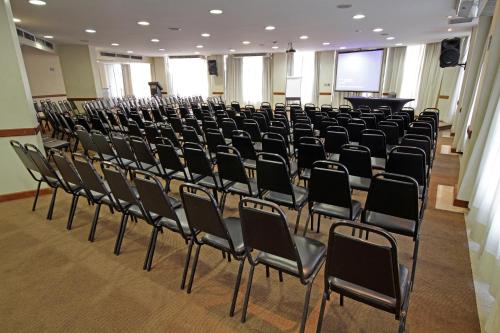 an empty room with chairs and a podium at San Raphael Hotel in Sao Paulo