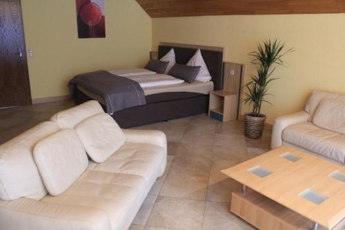 a living room with a couch and a bed at Haus Schieferstein in Dahlem