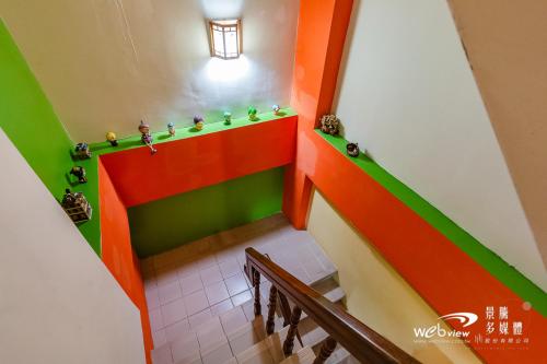 a staircase in a room with colorful walls at New Fox Guest House in Zhuangwei