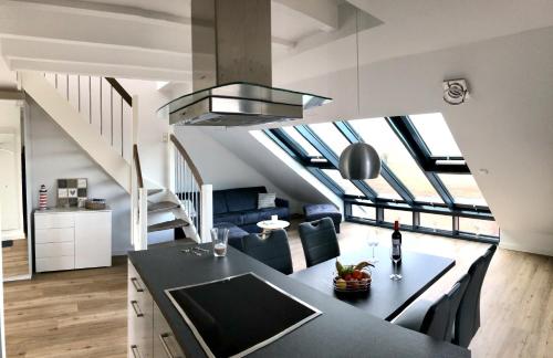 a kitchen and living room with a loft conversion at Nummer Zwo in Helgoland
