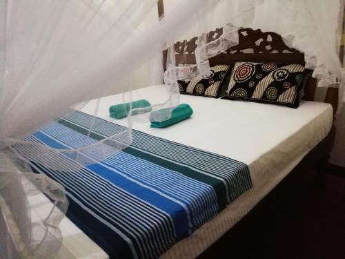 Postel nebo postele na pokoji v ubytování Jungle guest ,Mirissa