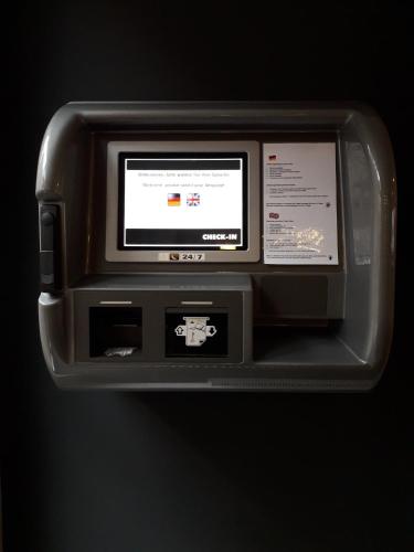 a computer monitor is attached to a wall at Internationales Studierendenhotel in Stuttgart