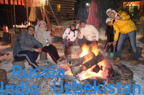 a group of people sitting around a fire at Heidi Korea in Hongcheon