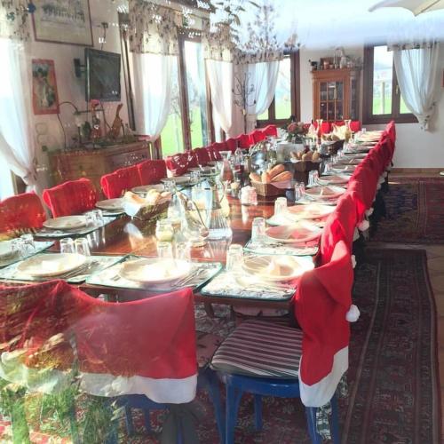 a long long table with santa hats on it at Country House Salomè in Musile di Piave