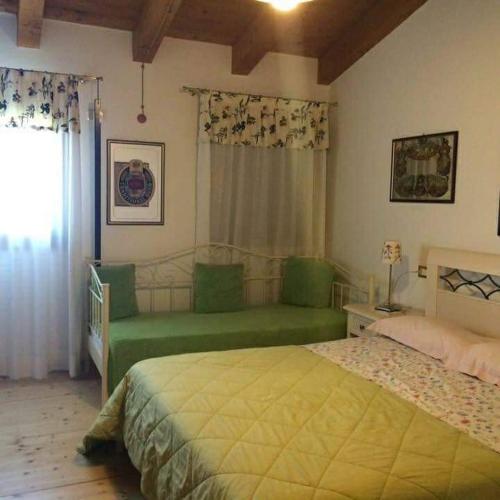 a bedroom with two green beds and a window at Country House Salomè in Musile di Piave