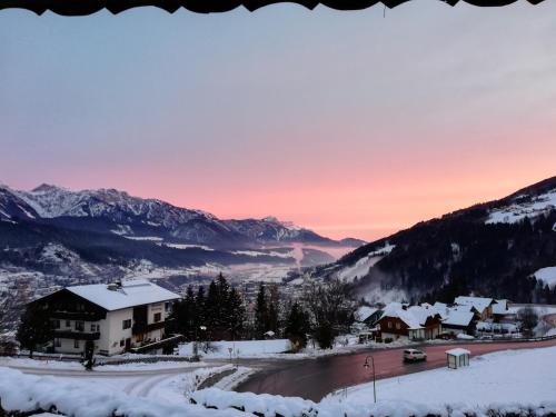 a village in the mountains in the snow at sunset at Apartment Alpenperle in Schladming