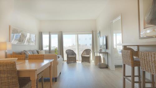 a living room with a couch and a table and chairs at Sea Crest in Amagansett