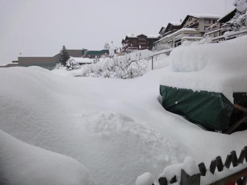 a pile of snow on top of a fence at Lehmann's Herberge Hostel in Grindelwald