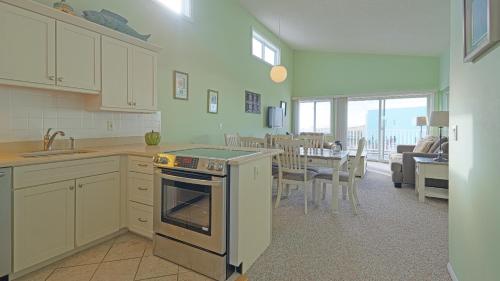 a kitchen with an oven and a dining room at Sea Crest in Amagansett
