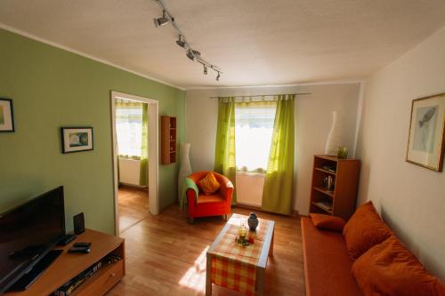 a living room with a couch and a chair at flat2let Apartment 1 in Frankfurt/Main