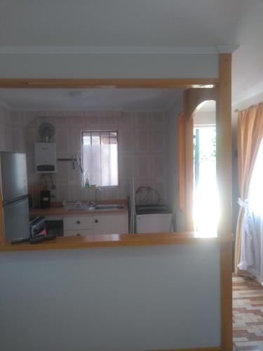 a kitchen with a refrigerator and a counter top at Departamento Familiar in Coquimbo