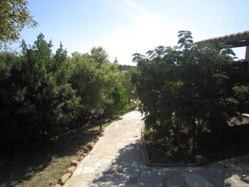 a stone path with trees on either side at Hotel Belvedere in Teulada