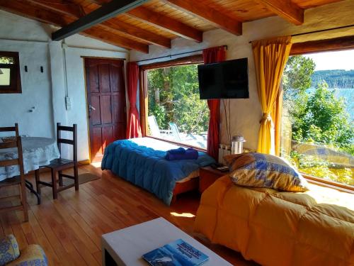 Ένα ή περισσότερα κρεβάτια σε δωμάτιο στο Murmullos del Lago