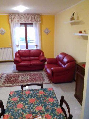 a living room with a couch and a table at Casa Vacanze "Ai piedi di Assisi" in Bastia Umbra
