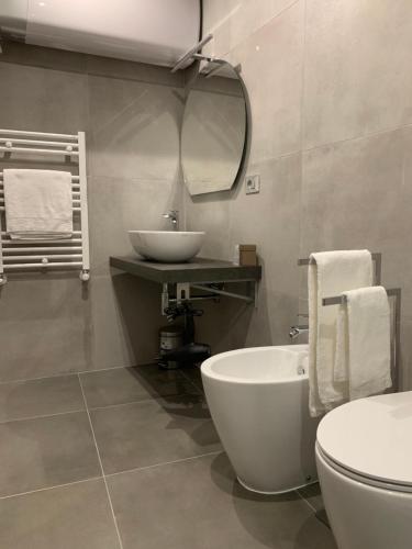 a bathroom with a sink and a tub and a toilet at ApartHotel Bossi in Milan