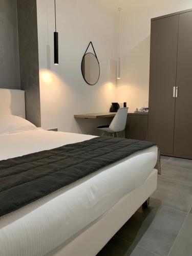 a bedroom with a bed and a desk and a chair at ApartHotel Bossi in Milan