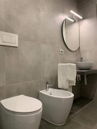 a bathroom with a white toilet and a sink at ApartHotel Bossi in Milan