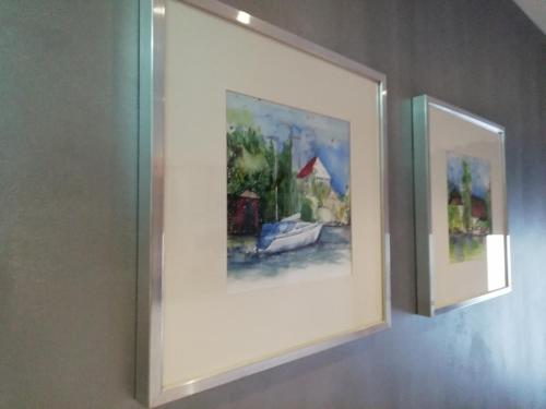 two framed paintings on a wall in a room at Landhotel Anna in Sankt Martin am Tennengebirge