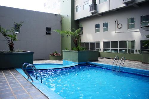 a swimming pool in front of a building at Scandinavian Asia Afrika in Bandung