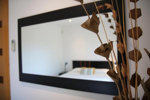 a mirror on a wall next to a bedroom at Pine Tree Apartments - Praia da Coelha - Albufeira in Albufeira
