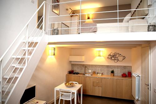 a kitchen and dining room with a loft bed at TrinaSicula Ragusa Ibla in Ragusa