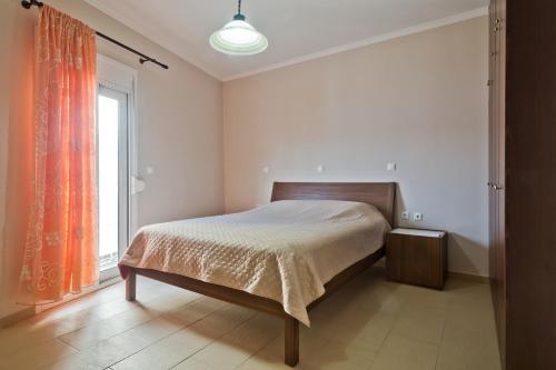 a bedroom with a bed and a window at Lux Sea View Apartment in Karpathos