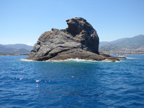 a large rock in the middle of the water at Villa Maria in Patti