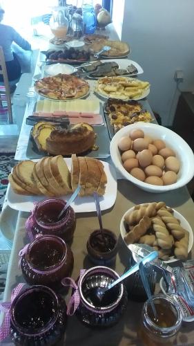 a table topped with lots of different types of food at Hotel Arhontiko Vourloka in Pramanta