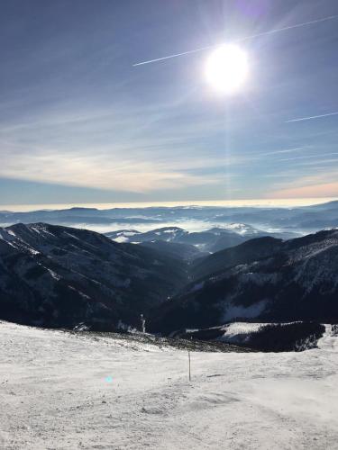 a view from the top of a snow covered mountain at Romantic Chopok Juh Apartment 22 in Tale