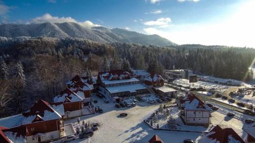 an aerial view of a ski resort in the snow at Monterai Resort in Poiana Brasov