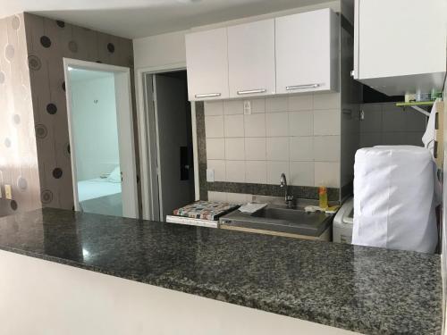a kitchen with a sink and a counter top at Apartamento na melhor localização de fortaleza!! in Fortaleza