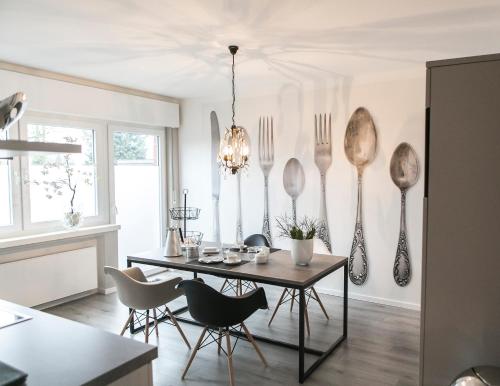a dining room with a table and utensils on the wall at Quartier 23 in Nordhorn
