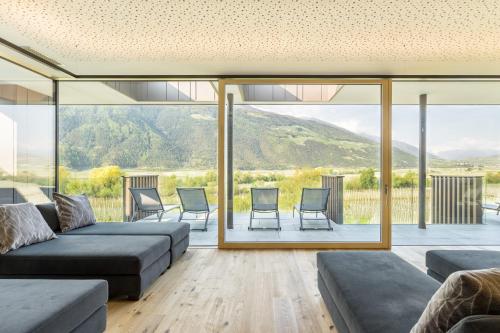a living room with a couch and chairs at Vinschgerhof in Silandro