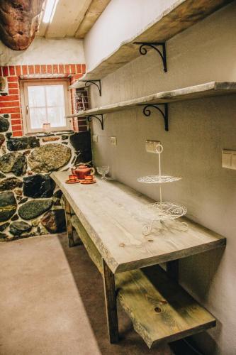 a large wooden table in a room with a window at Loovälja Guesthouse in Limu