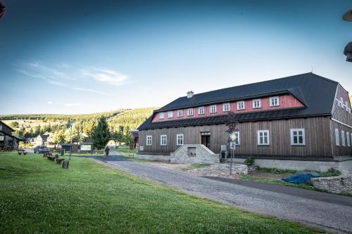 a large brown barn with a black roof at Stará škola in Dolní Malá Úpa
