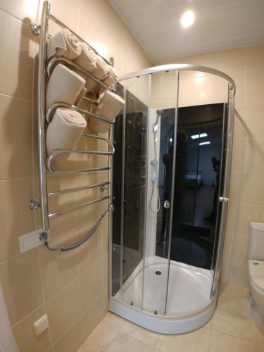 a shower with a glass door in a bathroom at M/S Factory Apartments in Tallinn